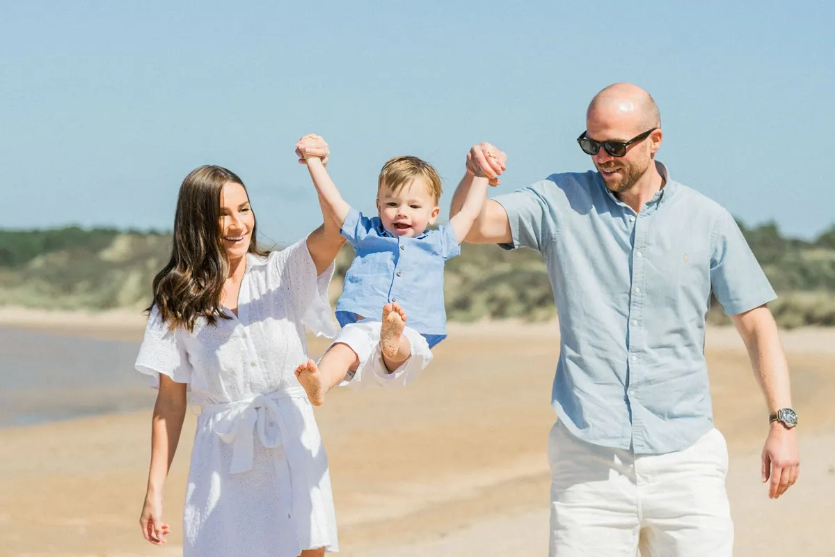 A family playing together on a sunny beach